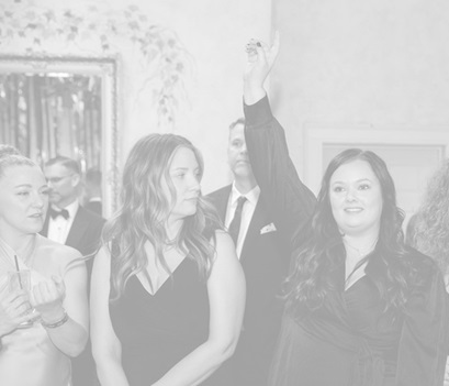 Black and white photo of a woman holding up her hand while others look on.